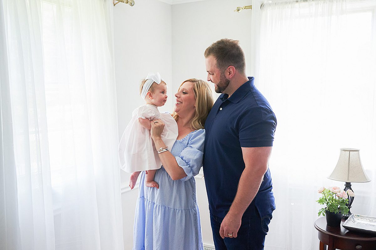 upper saint clair family photo session in home with mom and dad and child in the bedroom 