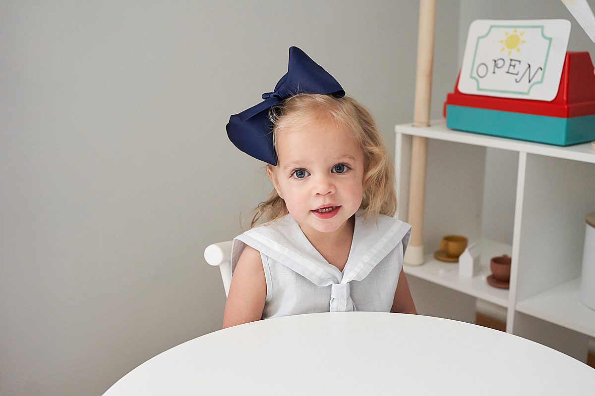 little girl at table in Upper Saint Clair Home for a family photo session 
