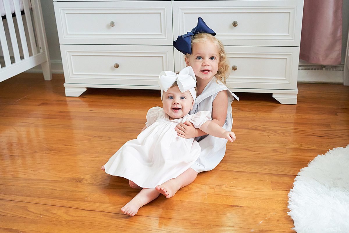 baby girl and big sister in nursery for family session in upper saint clair