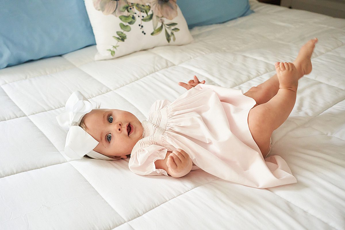 baby girl on bed for family session in upper saint clair
