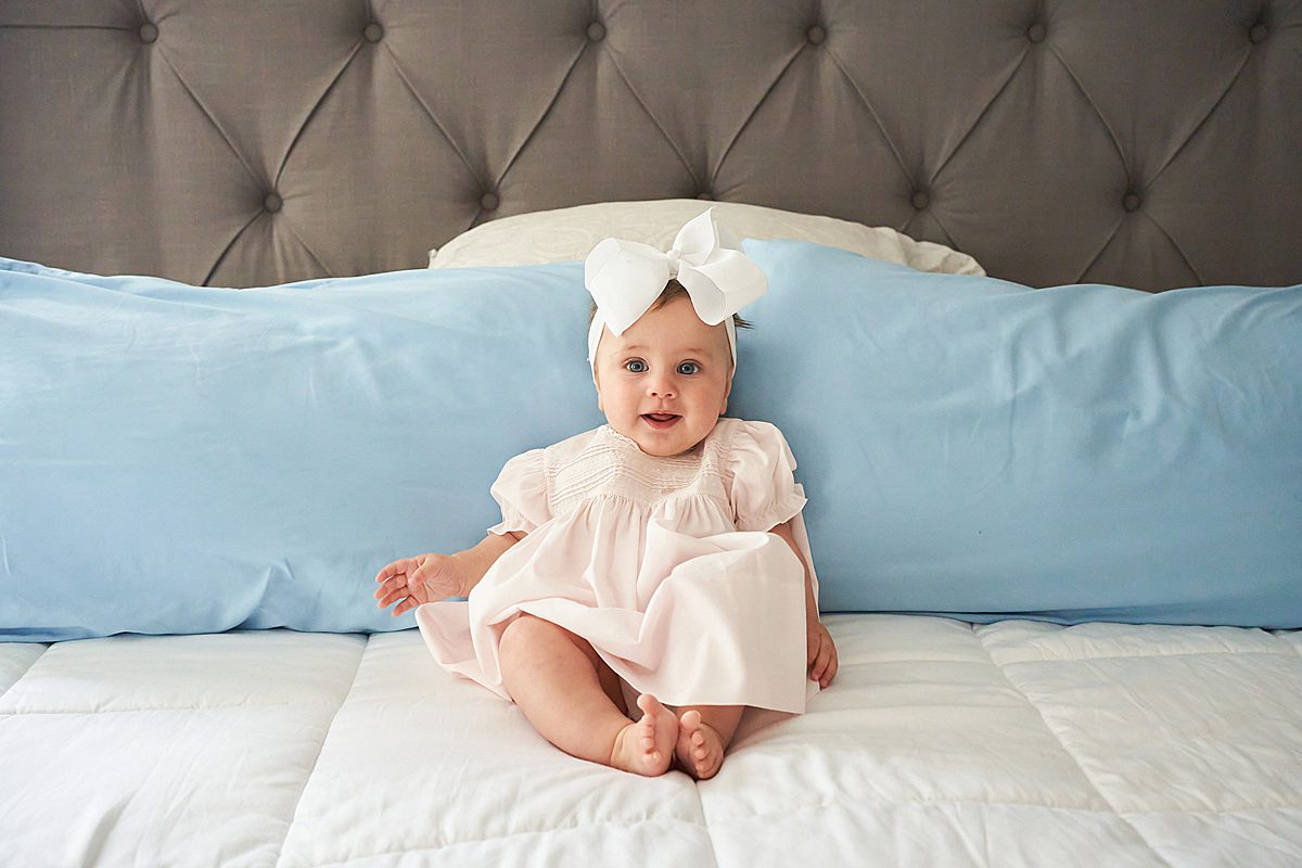 baby girl on bed for family session in upper saint clair