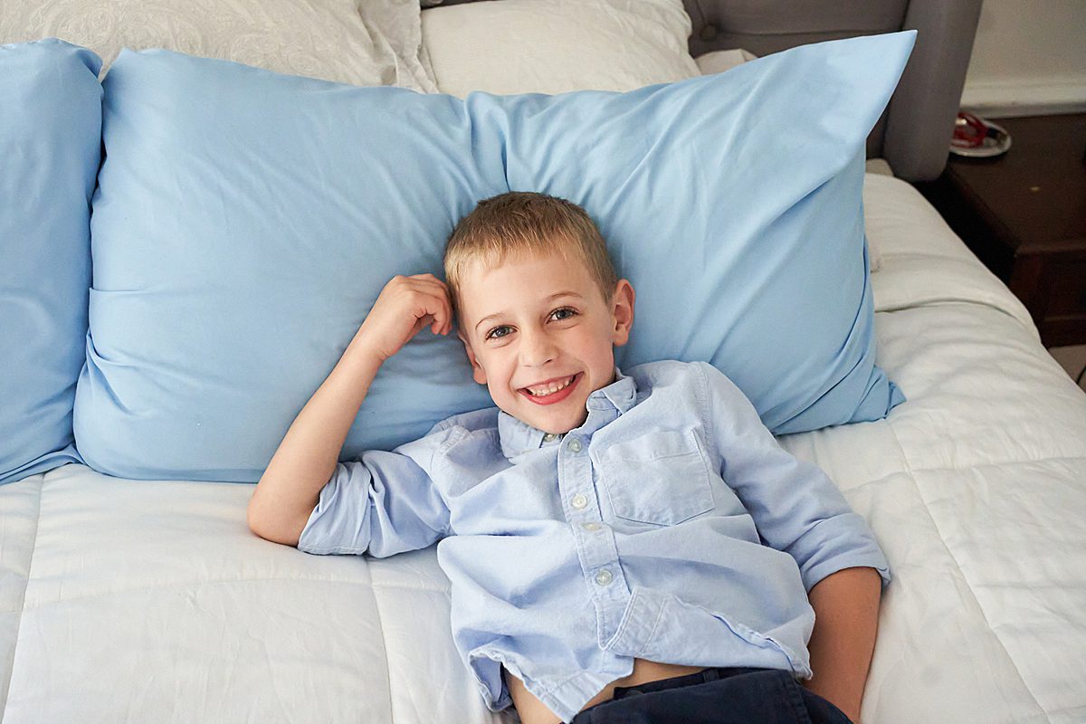 boy on bed for family session in upper saint clair