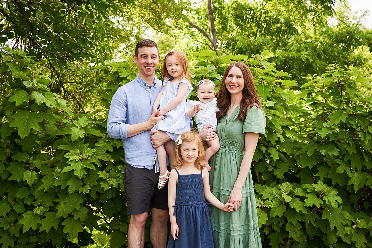 family smiling in front of green plants beechwood farms pittsburgh