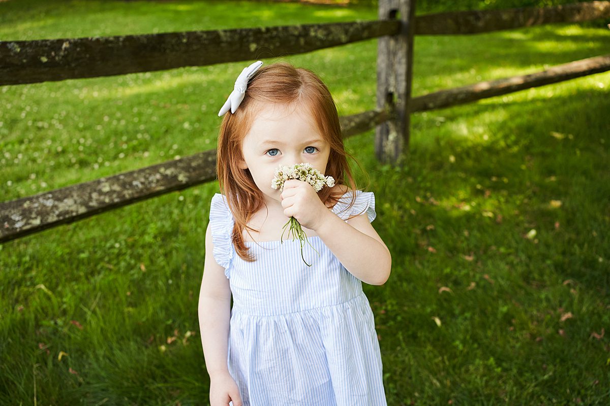 little girl red head smelling flowers beechwood farms pittsburgh