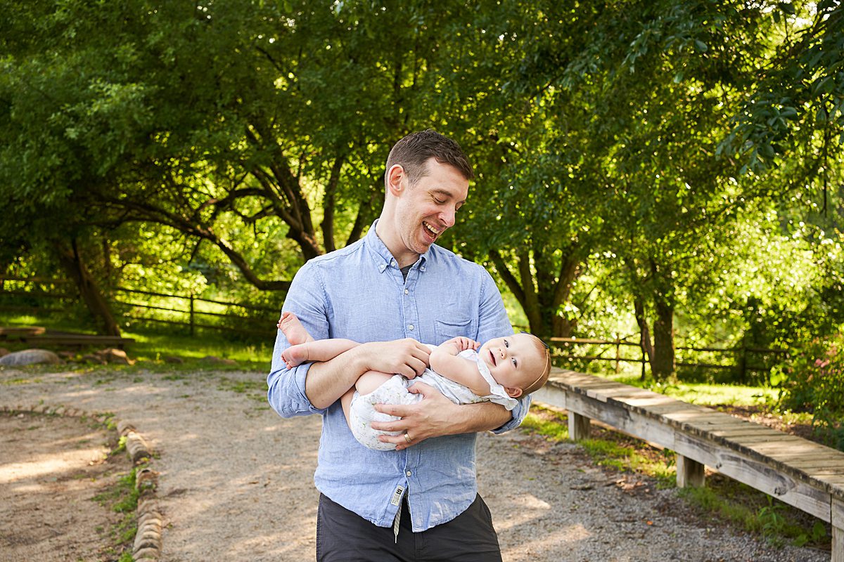 dad holding daughter at beechwood park in fox chapel for a family photo session 