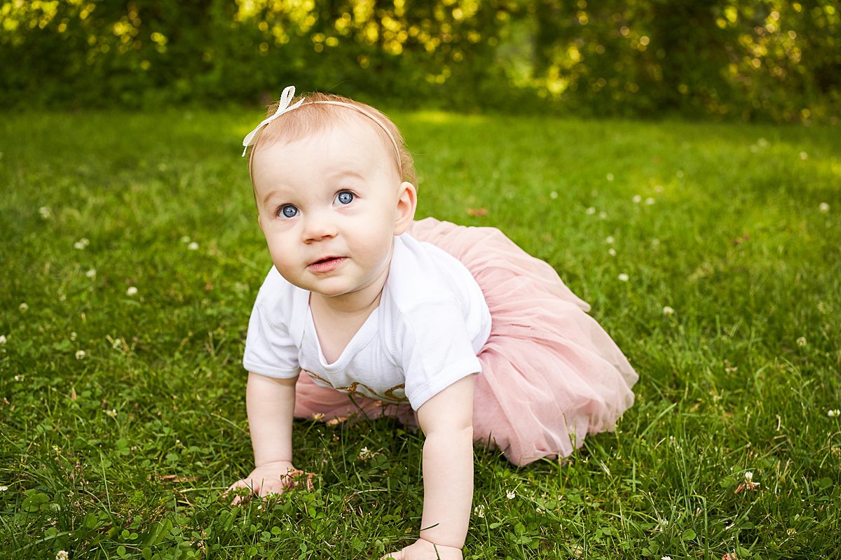 baby girl in first birthday outfit in beechwood park in fox chapel for a family photo session 