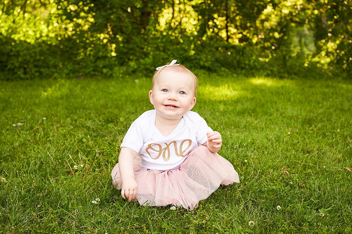 baby in first birthday outfit in beechwood park in fox chapel for a family photo session 