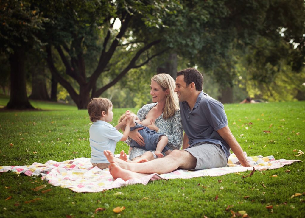 Lactation and Breastfeeding Support in the Pittsburgh Area mom nursing baby in park with family 