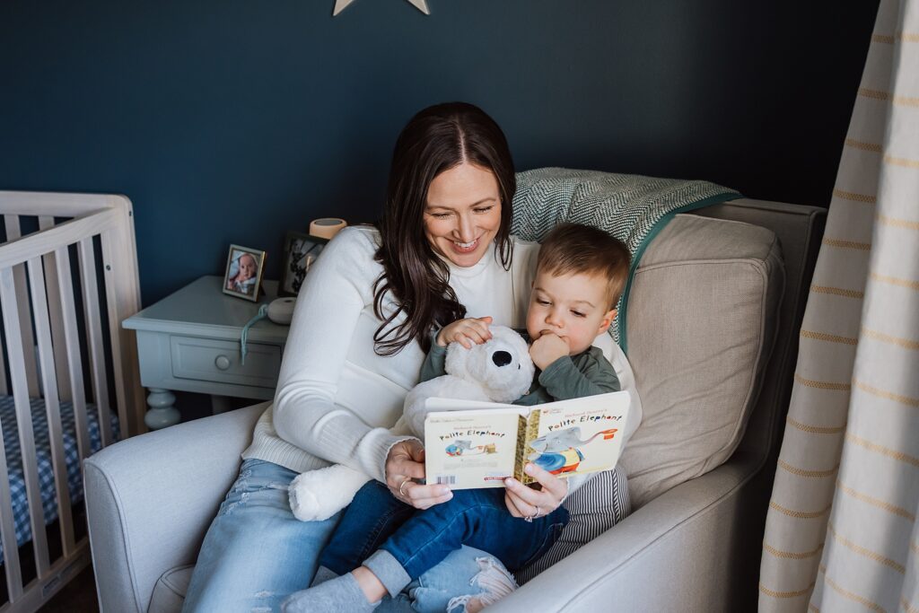 mom and toddler reading a book in nursery of wexford home for a family photo session 