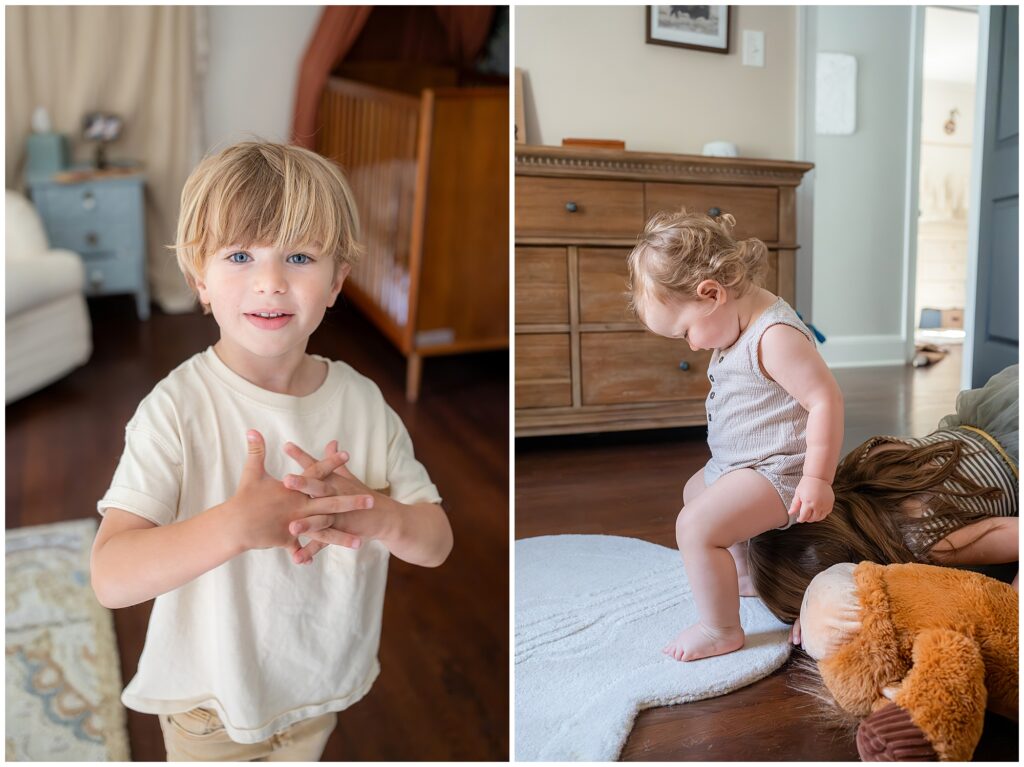 Two young children are in a cozy room. On the left, a boy in a white shirt clasps his hands. On the right, a toddler in a gray outfit stands on a white rug, with furniture and toys in the background.