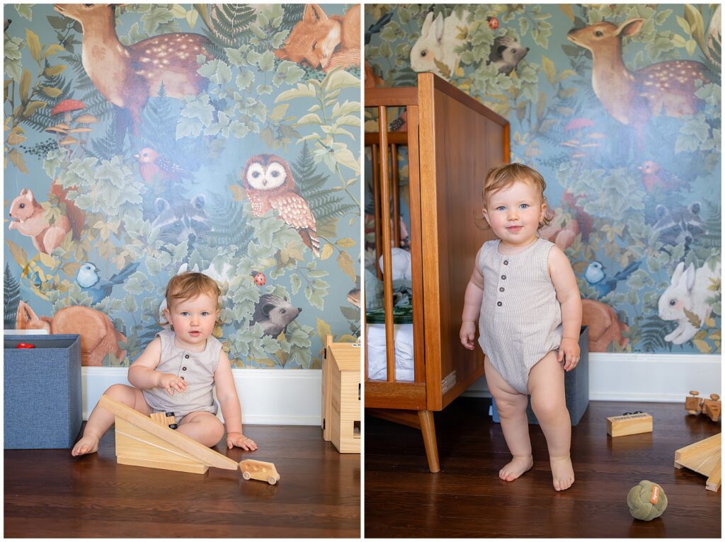 A toddler in a beige romper plays with wooden toys in a room with animal-themed wallpaper. The child is seen sitting and standing next to a wooden crib.