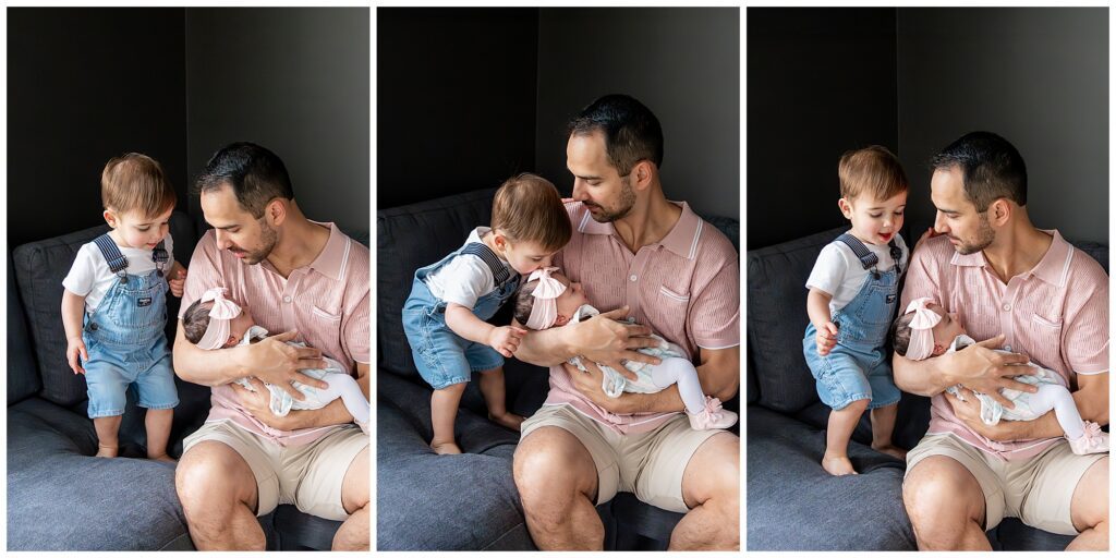 A man sits on a gray sofa holding a baby in a soft blanket, while a toddler looks curiously, interacting with them. The setting is a dimly lit room, captured in three side-by-side images.