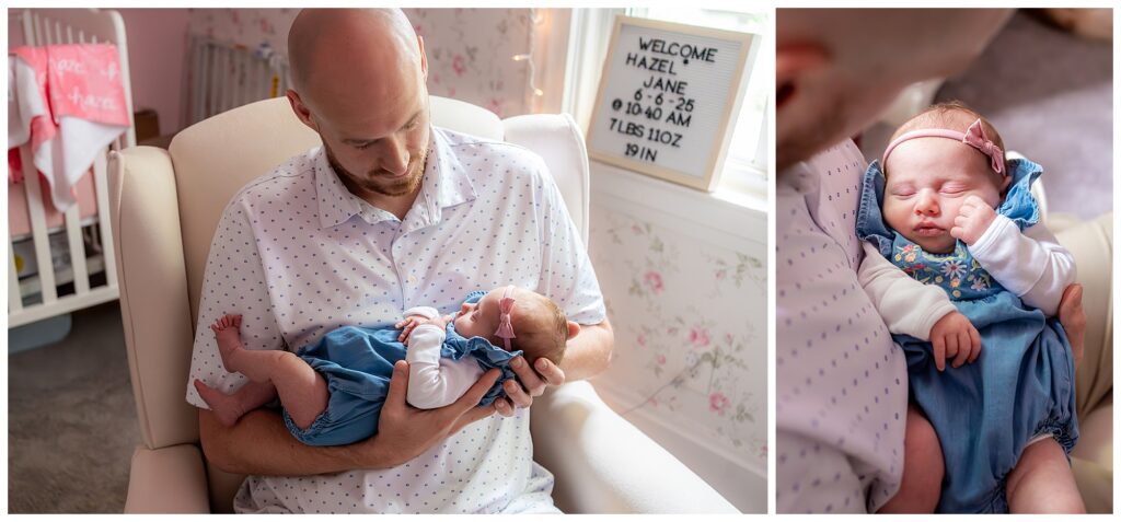 A man sits in a nursery holding a newborn baby dressed in blue. A sign in the background provides the baby’s name and birth details.