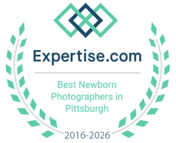 Expertise.com badge reading “Best Newborn Photographers in Pittsburgh 2016-2026,” framed by laurel leaves with a geometric logo at the top.